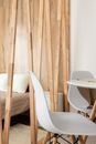 Chairs against bed and partition in modern house