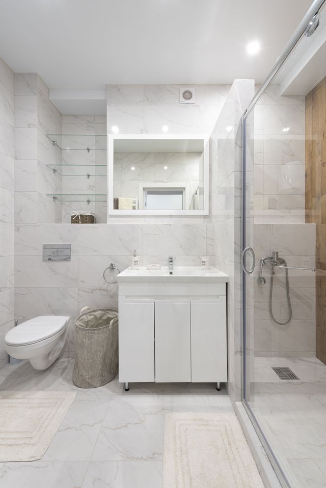 Modern Marietta bathroom with marble finishes, a walk-in shower, and a new sink installation
