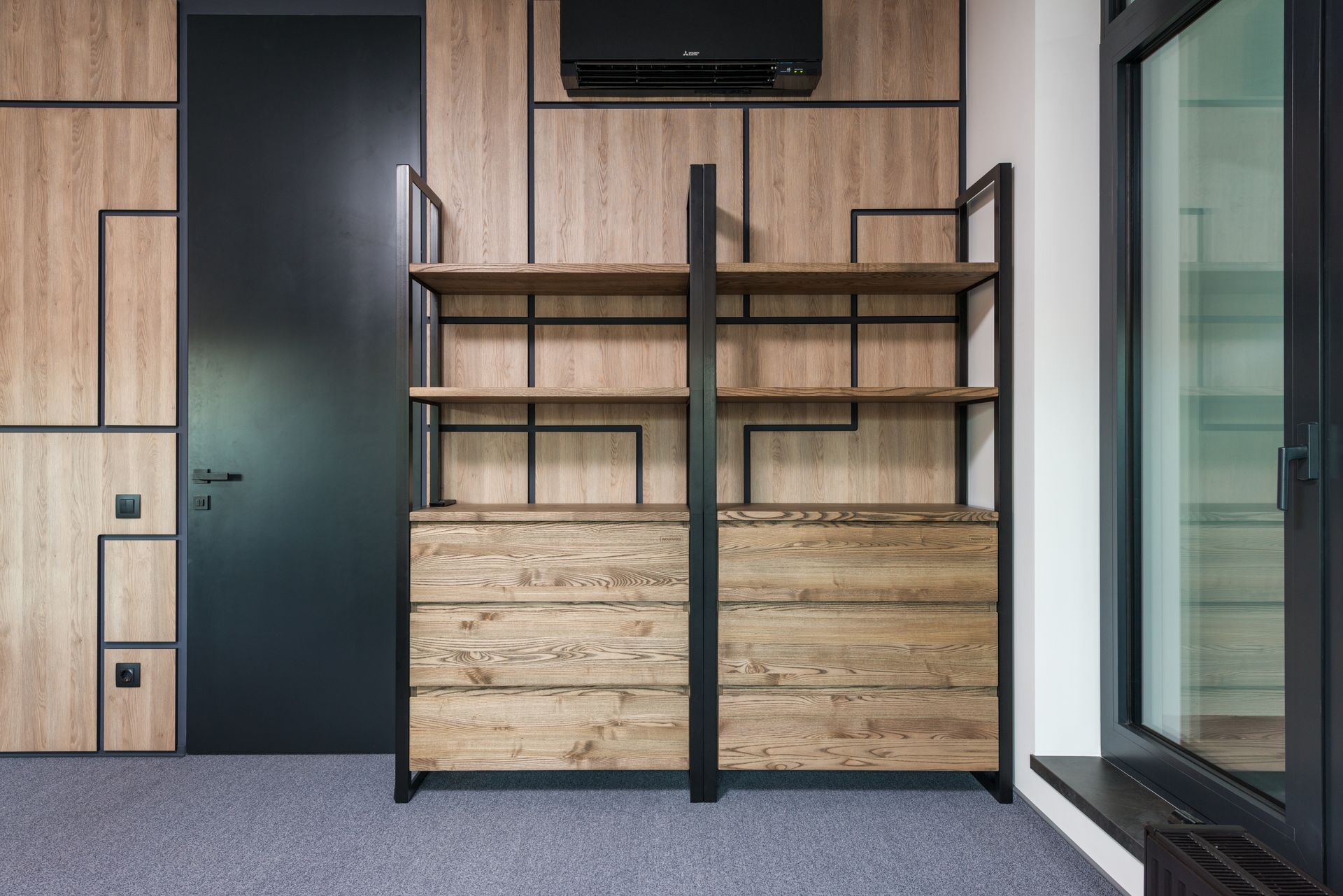 Contemporary interior design featuring wooden shelves and geometric patterns for home or office space.