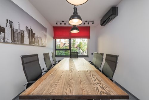 Free Contemporary workspace interior with photo of city against lamps over desk and armchairs in daytime Stock Photo