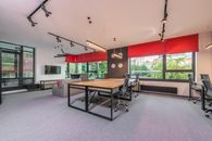 Modern office interior with furniture and lamps against windows