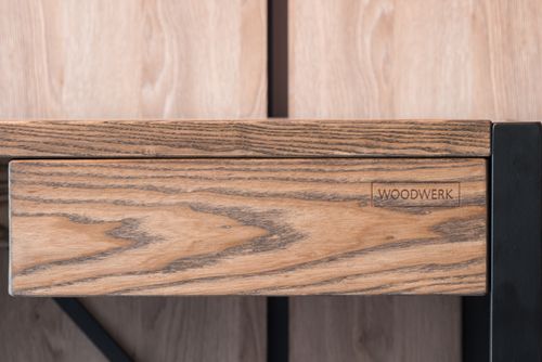 Free Creative design of wooden table with drawer and logotype of woodwork company against wall in contemporary workspace Stock Photo