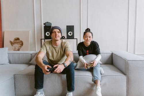 Free A Man and Woman Playing a Video Game Stock Photo
