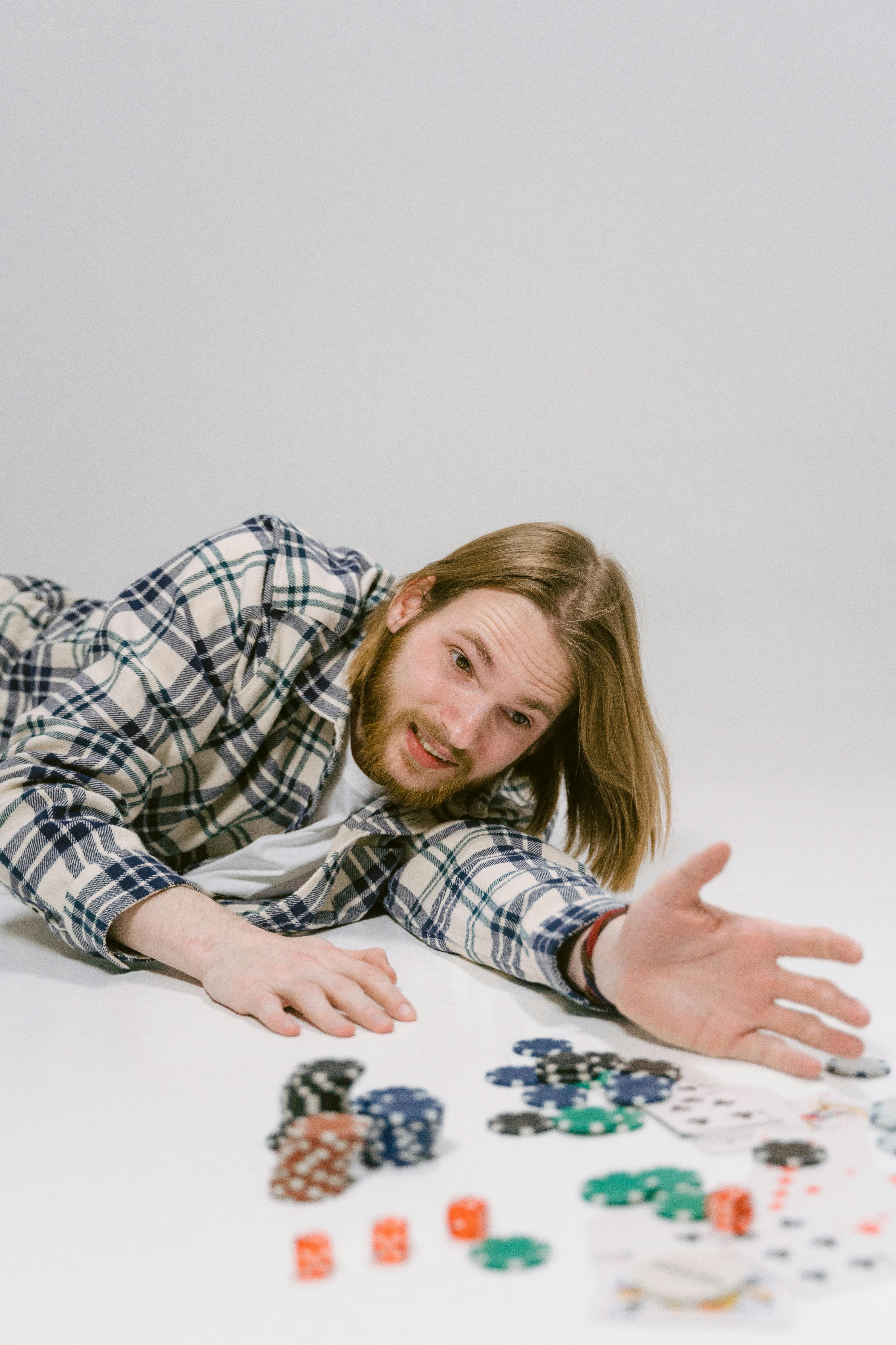 a man lying on a floor with poker chips