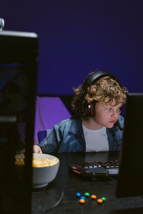 Free A Boy Playing a Computer Game Stock Photo
