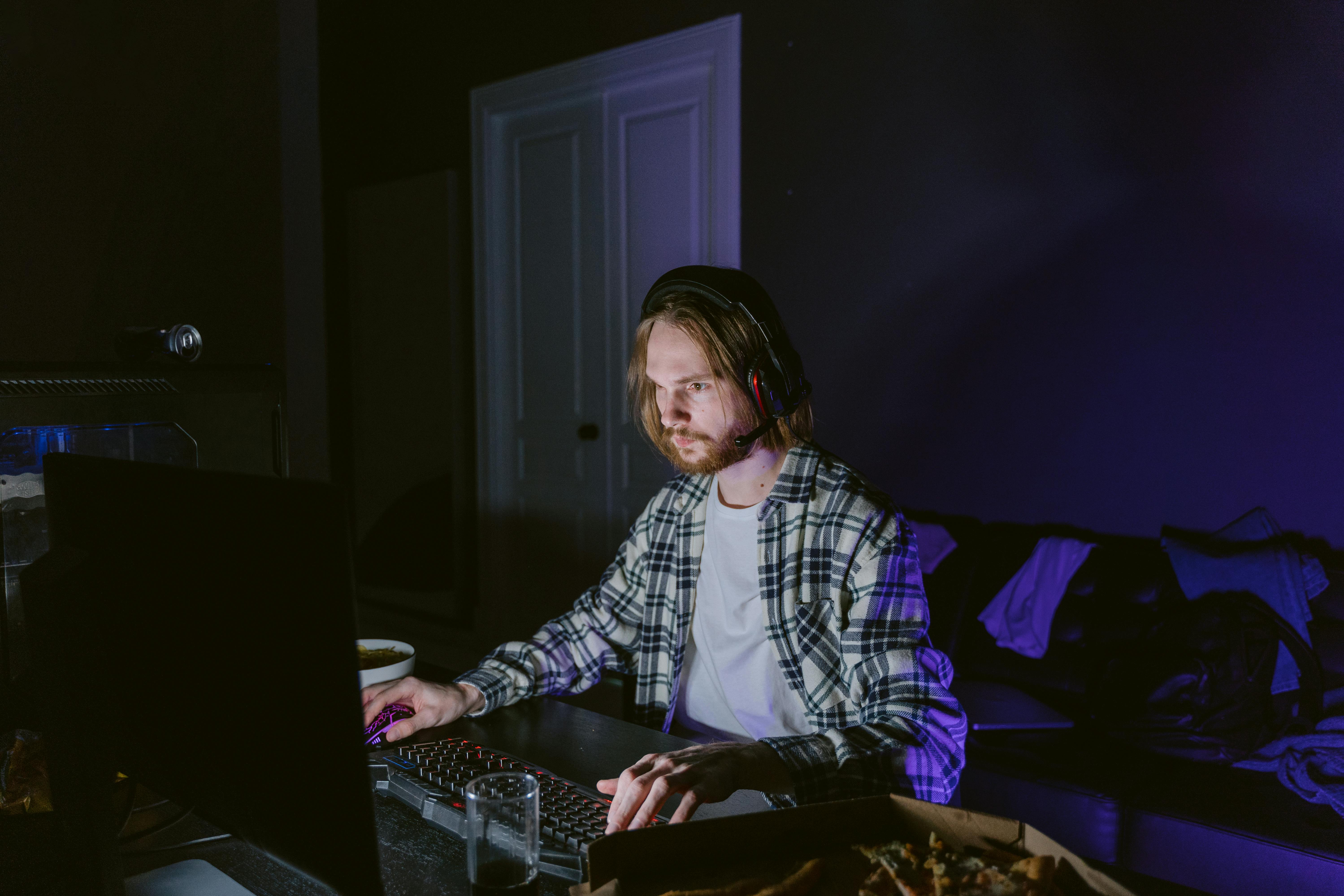 man in plaid shirt playing a computer video game