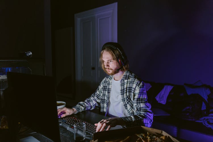 Man In Plaid Shirt Playing A Computer Video Game