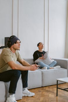 Young adults enjoying a video game session on a cozy sofa, creating a relaxed atmosphere.