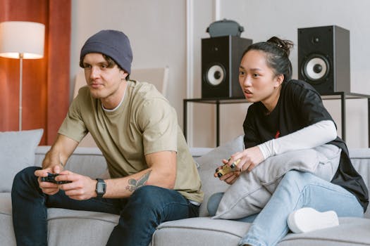 A man and woman intensely engaged in a competitive video game on a living room couch.