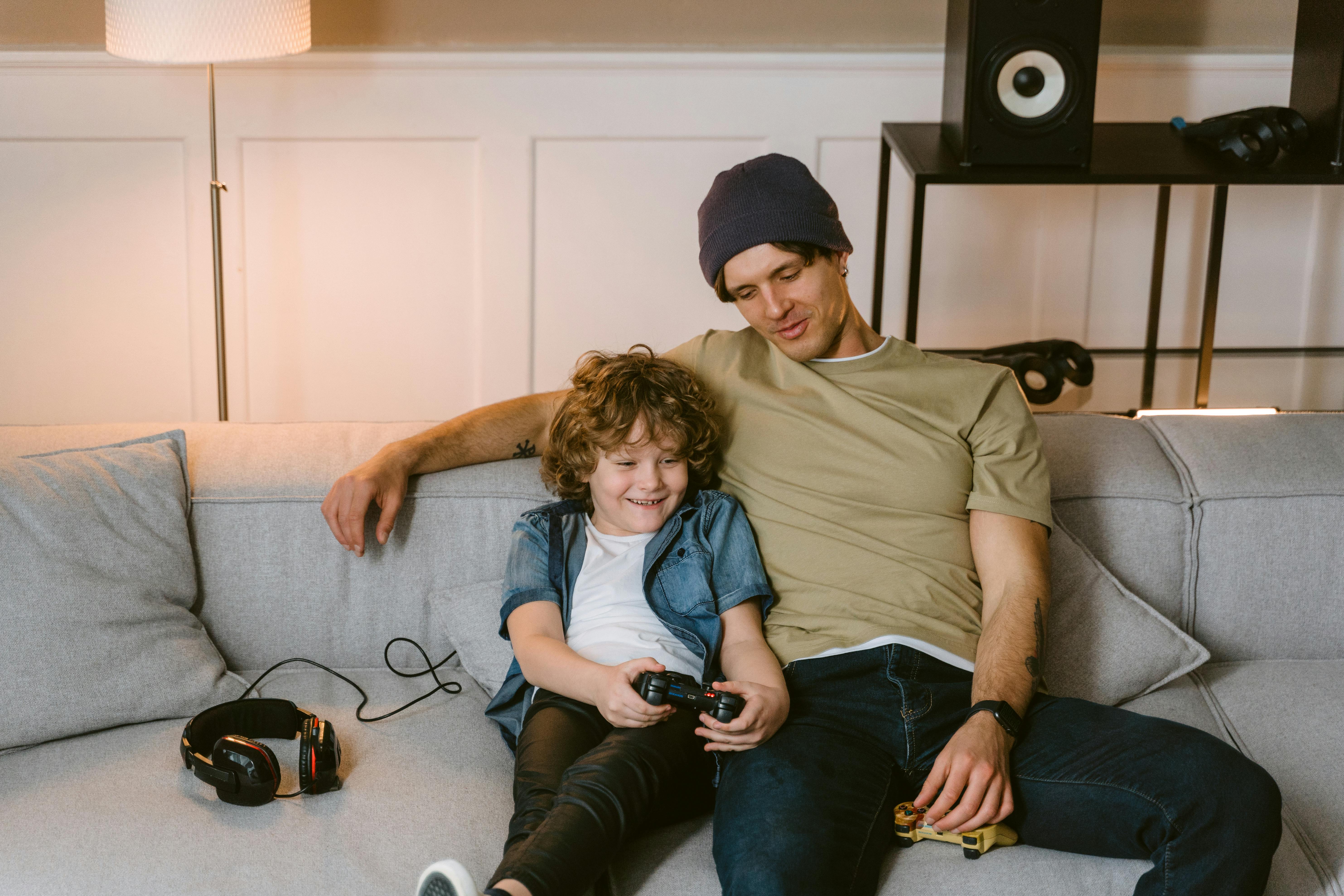 a father talking to his son while playing video game