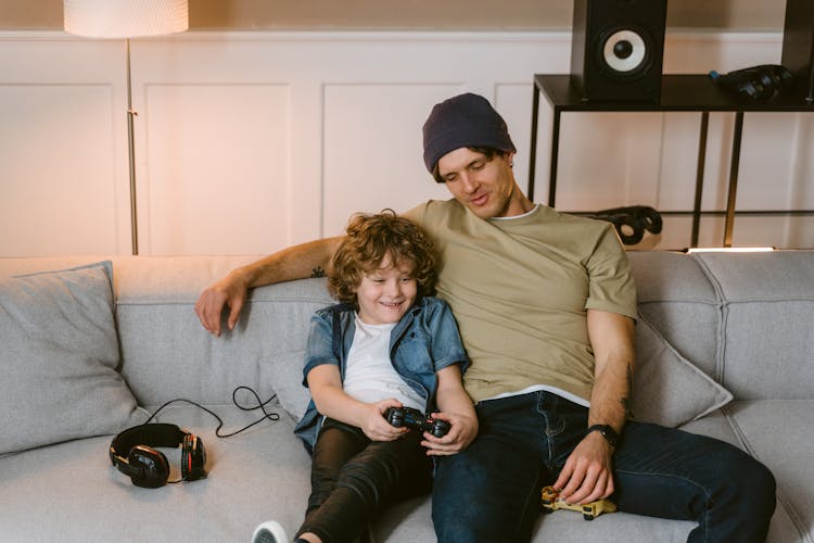 A Father Talking To His Son While Playing Video Game