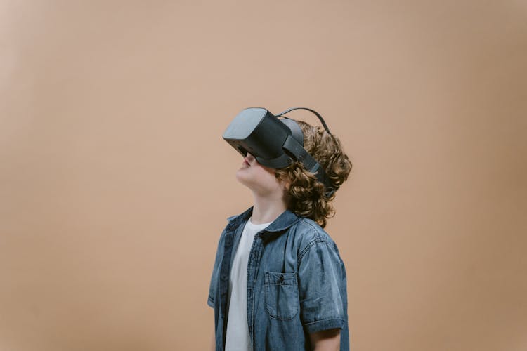 A Boy With VR Goggles Looking Up 