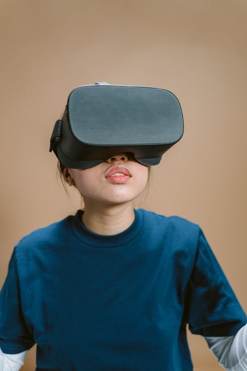 A Person in Blue Crew Neck Shirt Wearing VR Goggles