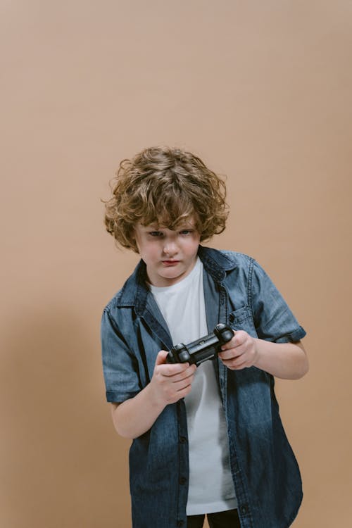 A Boy Holding a Video Game Controller