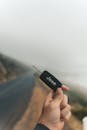 Shallow Focus Photo of a Person Holding a Black Jeep Car Key