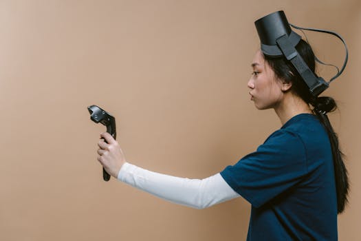 Side view of a woman wearing a VR headset, actively engaged with a VR controller against a neutral brown background.