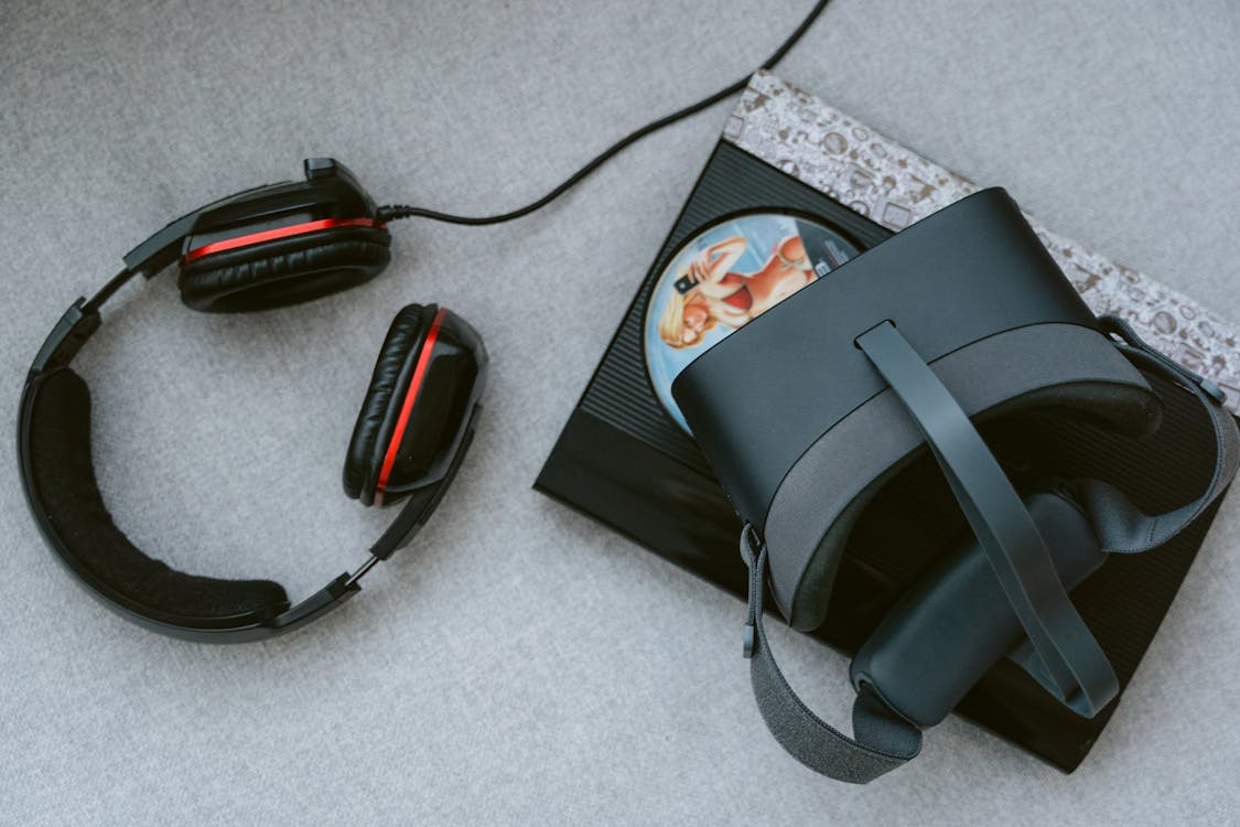 Black Virtual Headset and Headphones on the Floor