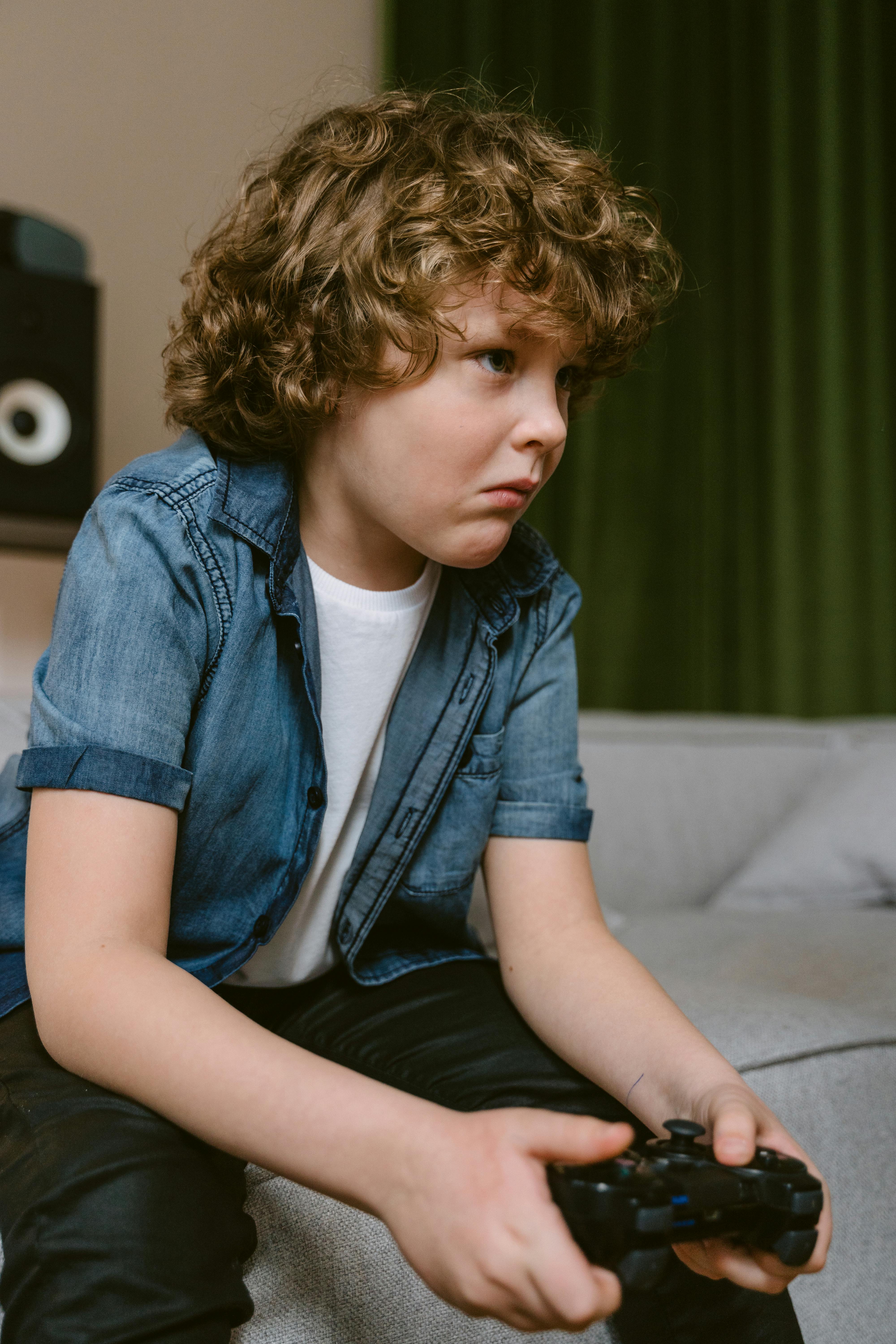 Boy playing a video game - Stock Image - T485/0068 - Science Photo