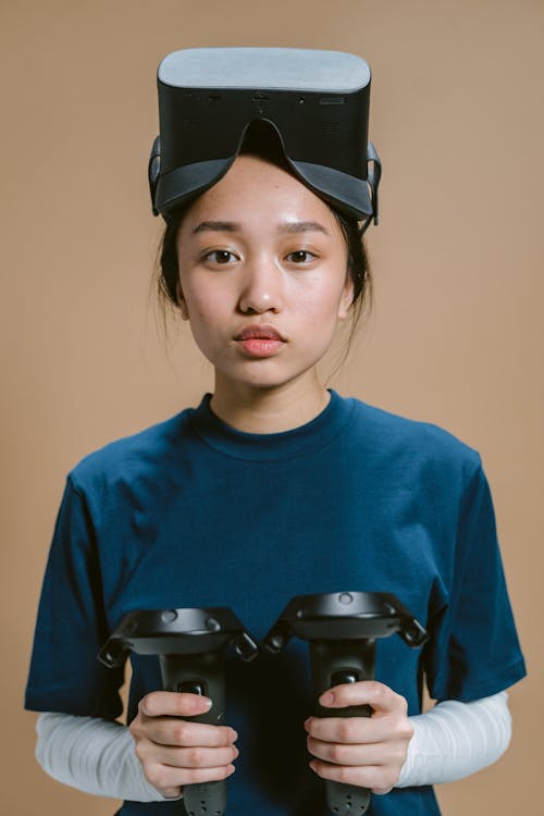 Close-Up Shot of a Woman with Virtual Reality Headset Looking at Camera