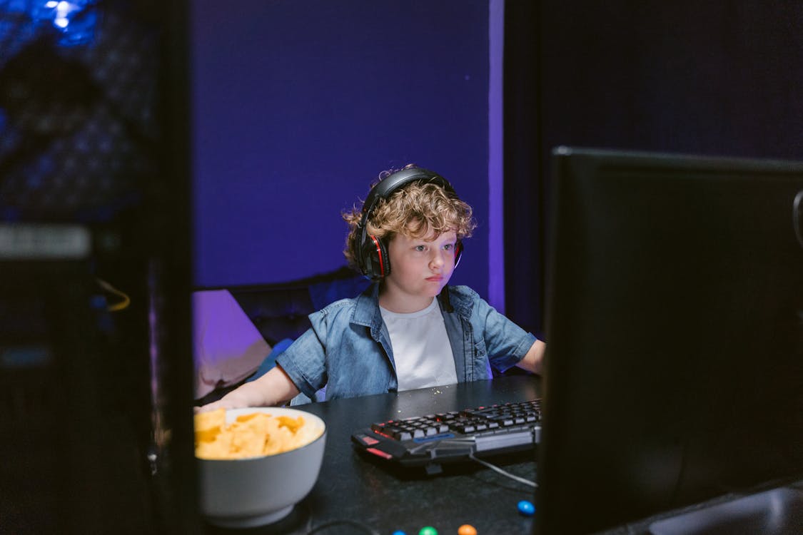 Little Boy Playing Car Game On Computer At Home Stock Photo