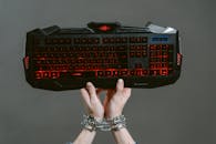 Person Holding Black and Red Computer Keyboard