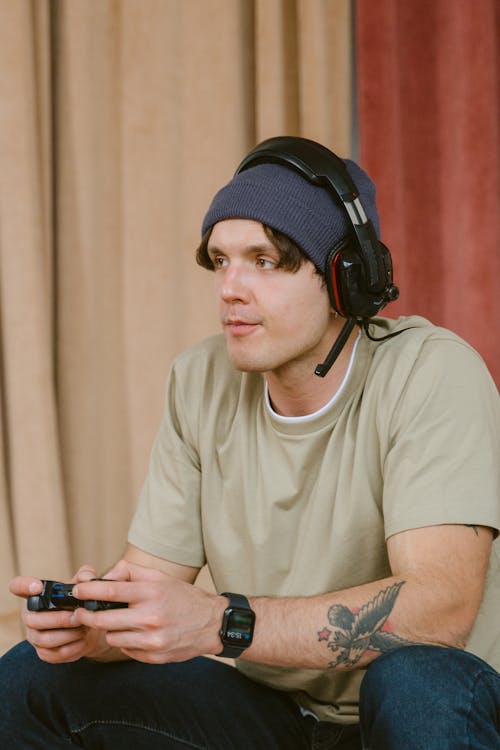 Man in Brown Crew Neck T-shirt Wearing Black Headphones