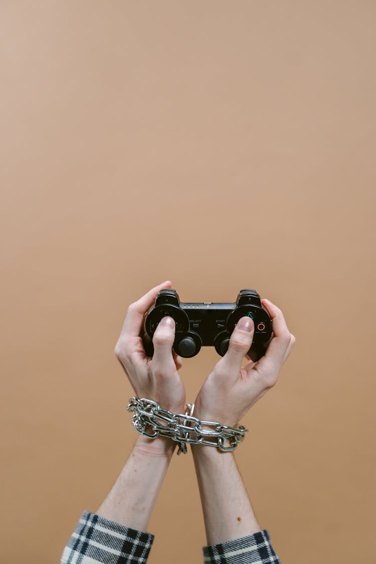 A Chained Hand Holding Game Controller