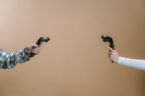 People Holding Virtual Reality Game Controllers