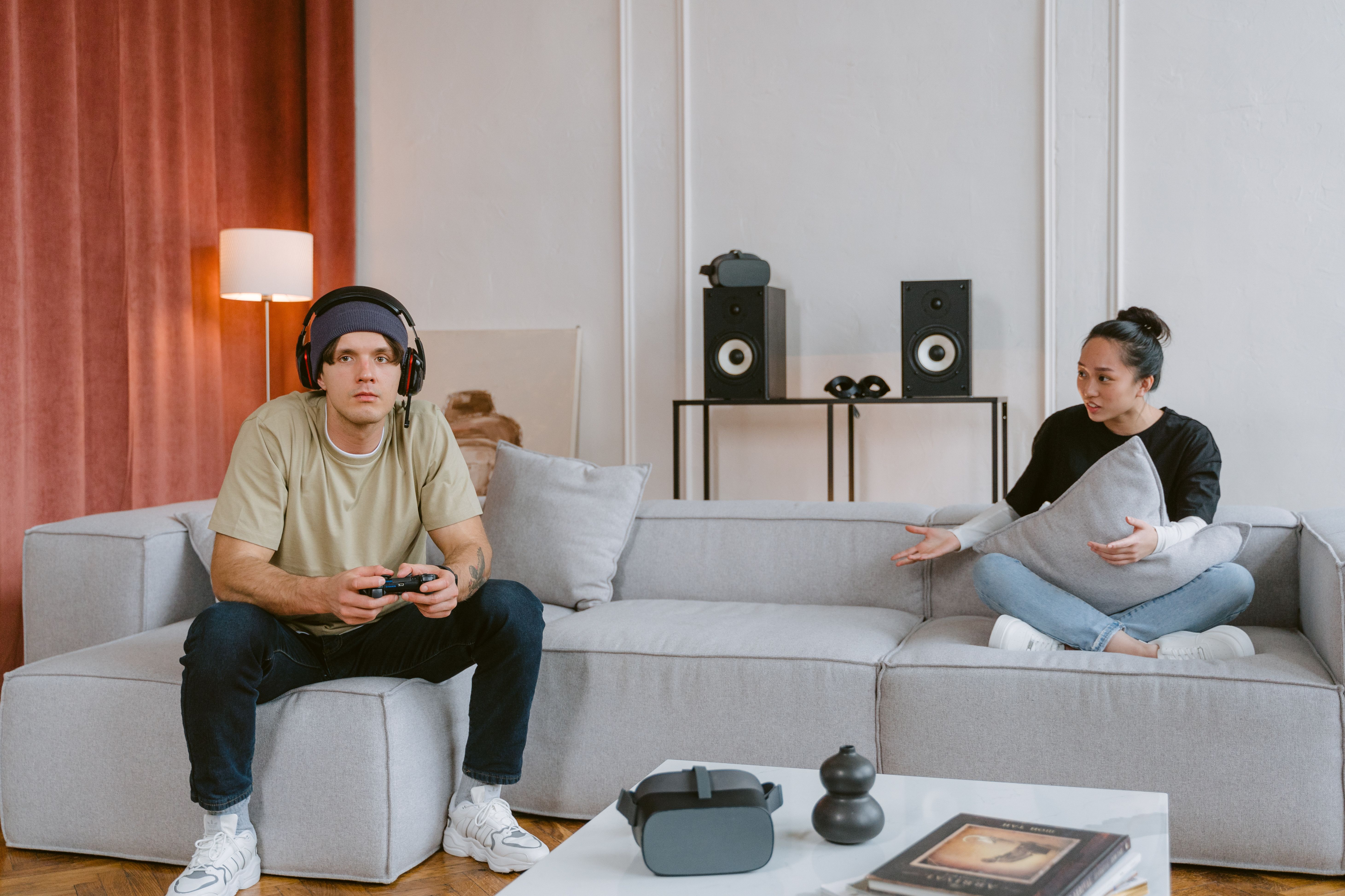 Free Couple engaging in video gaming in a modern living room setting, highlighting leisure and technology. Stock Photo
