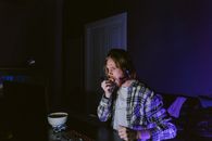 A Man Sitting in Front of a Computer Eating