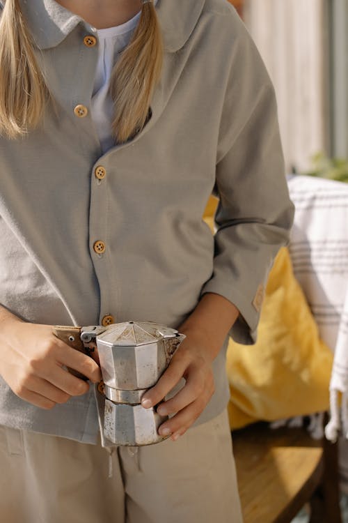 Free Woman in Gray Button Up Shirt Holding Silver Cup Stock Photo