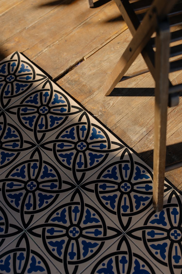 A Close-Up Shot Of Tiles And Hardwood Flooring