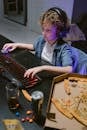 A Kid Wearing Headset Busy Typing on the Keyboard