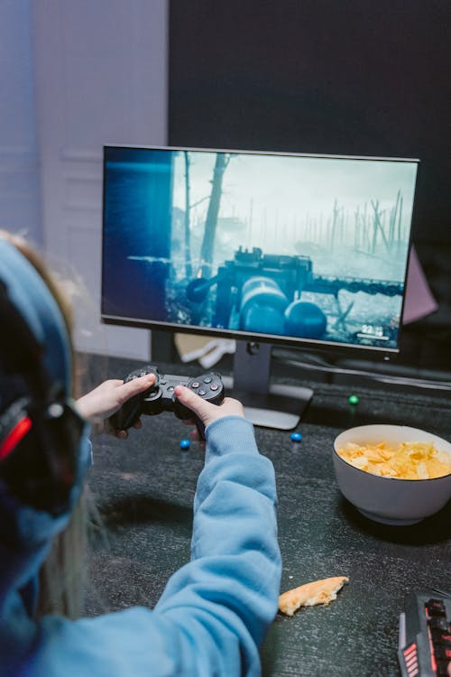 A Person Busy Playing while Holding Black Game Controller