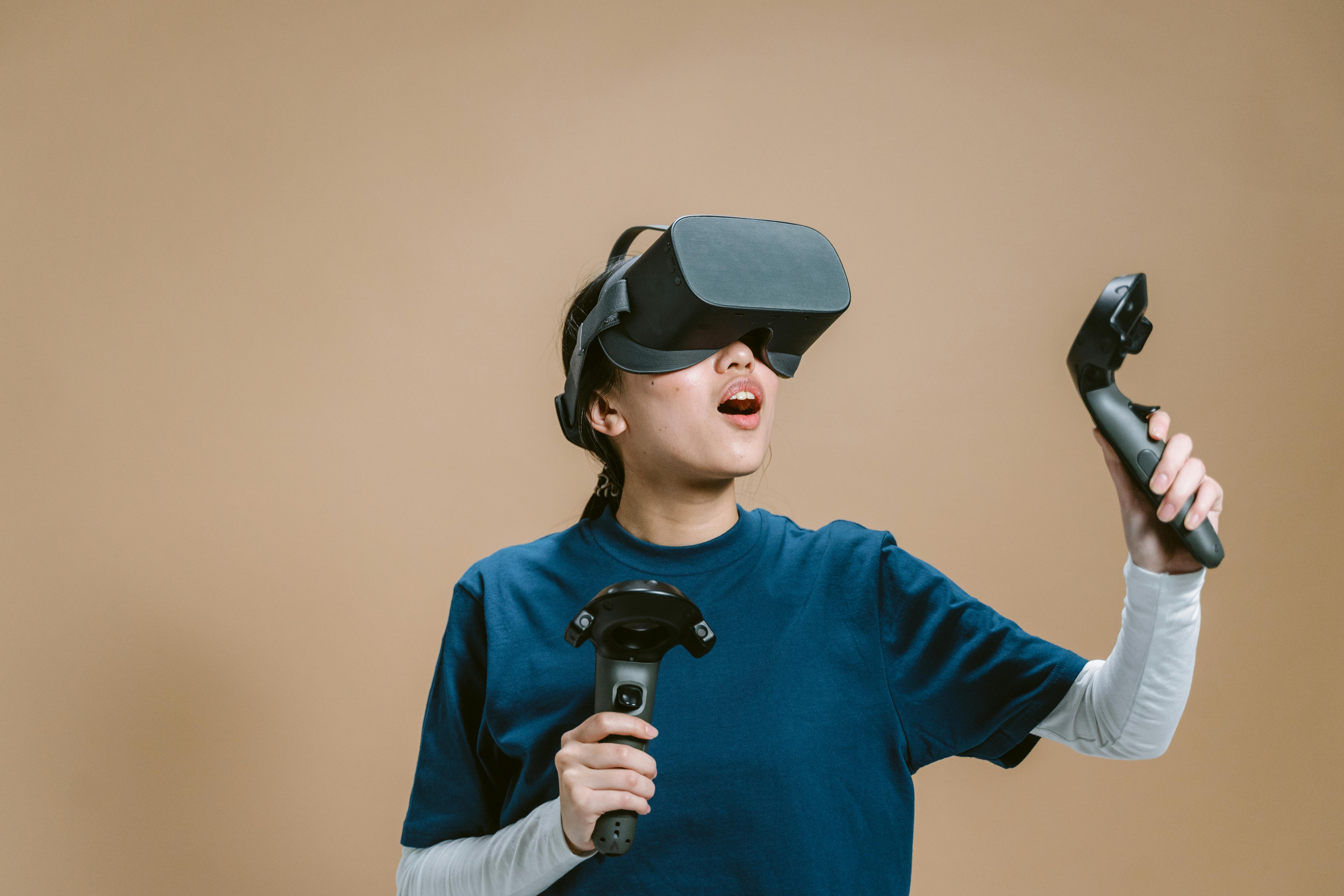 a woman wearing vr headset playing while holding a controllers