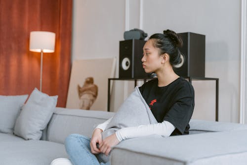 Sad Woman Sitting on Gray Sofa