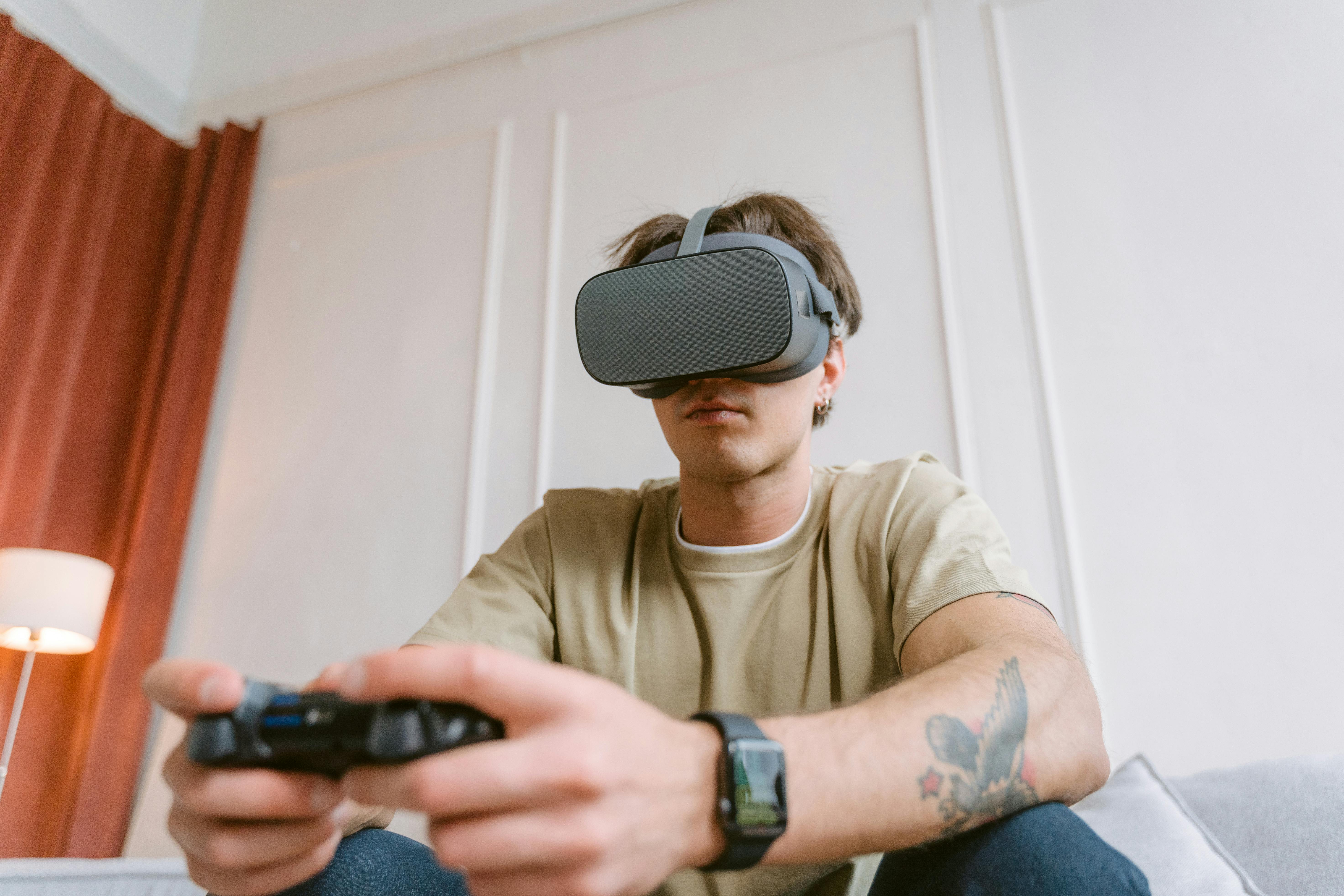 Adult male wearing a VR headset while intensely focused on playing a video game indoors.