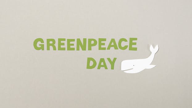 Minimalist paper cutout design for Greenpeace Day with whale illustration on copy space background.