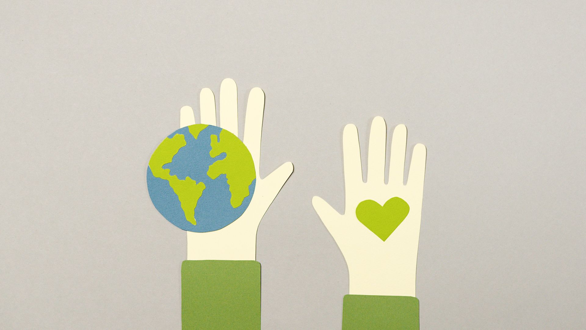 Creative paper cutout depicting environmental protection with Earth and heart symbols.
