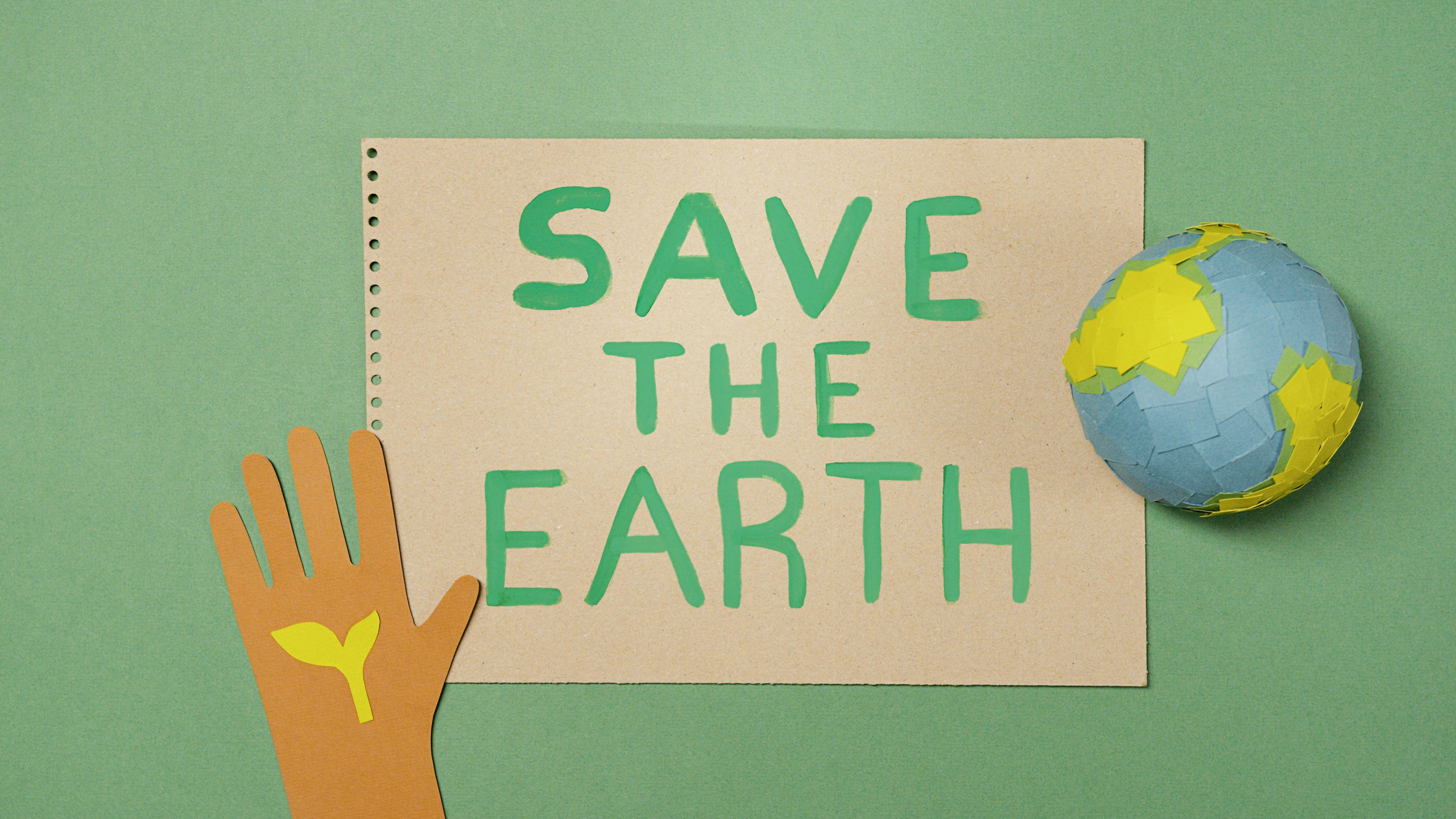 Eco-friendly concept with paper cutouts promoting earth protection and sustainability.