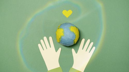 Free Illustration of hands with paper Earth and heart symbol representing environmental protection. Stock Photo