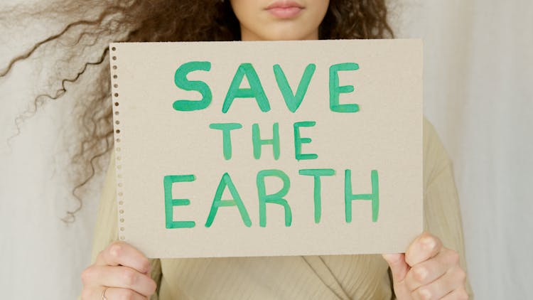 A Woman Holding A Sign