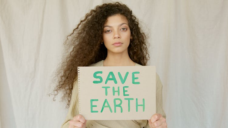 Woman Holding Save The Earth Sign