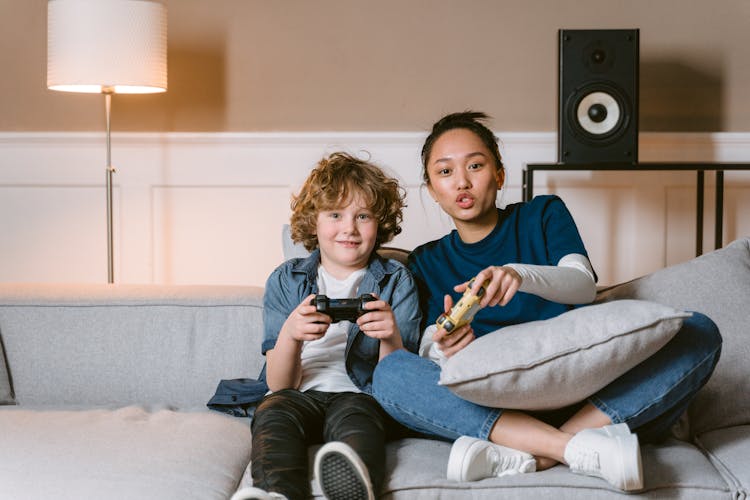 A Woman And A Boy Playing Video Games