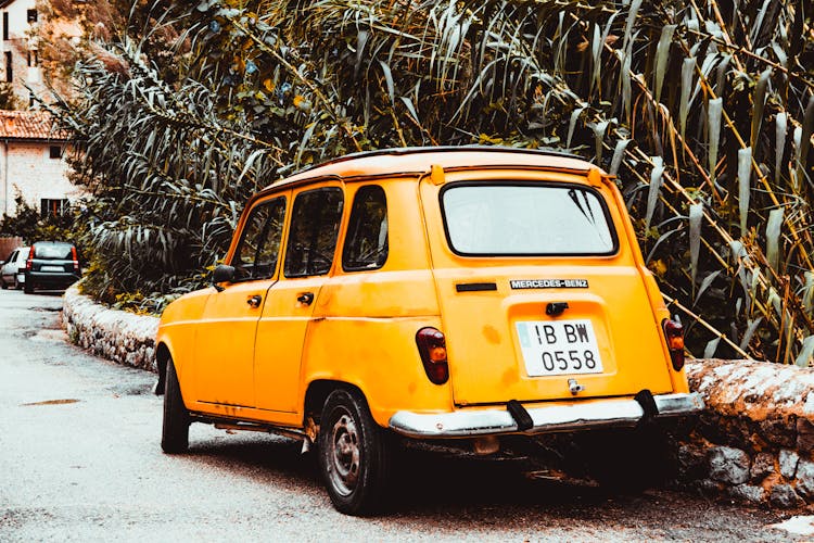 Classic Yellow Car On Side Of Road At Day