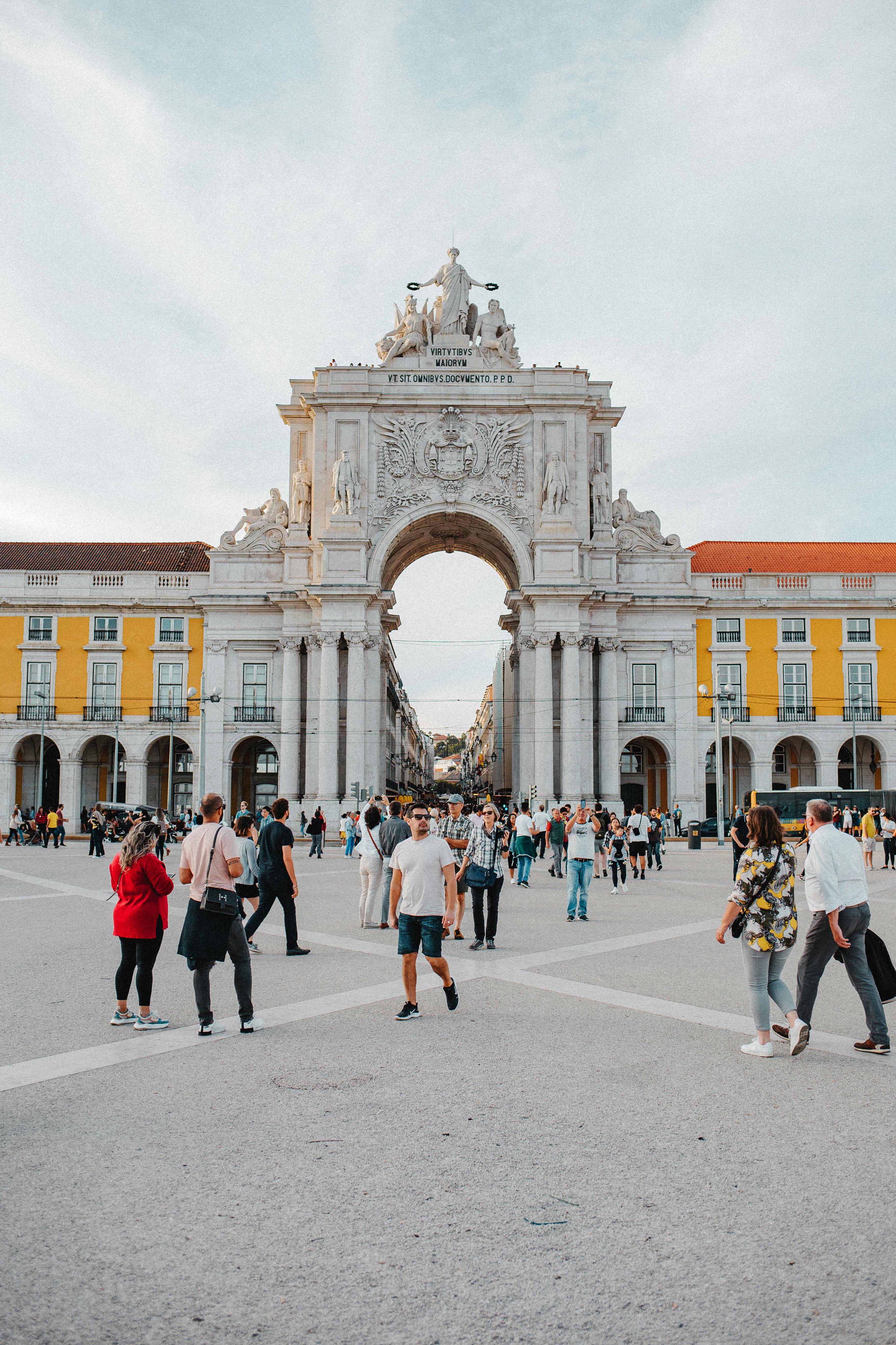 People walking at the Arco da Rua Augusta in Lisbon, a stunning architectural landmark.
