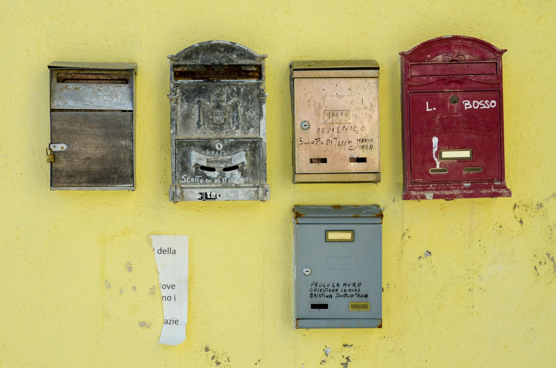 Old Letter Boxes Mounted on a Yellow Wall