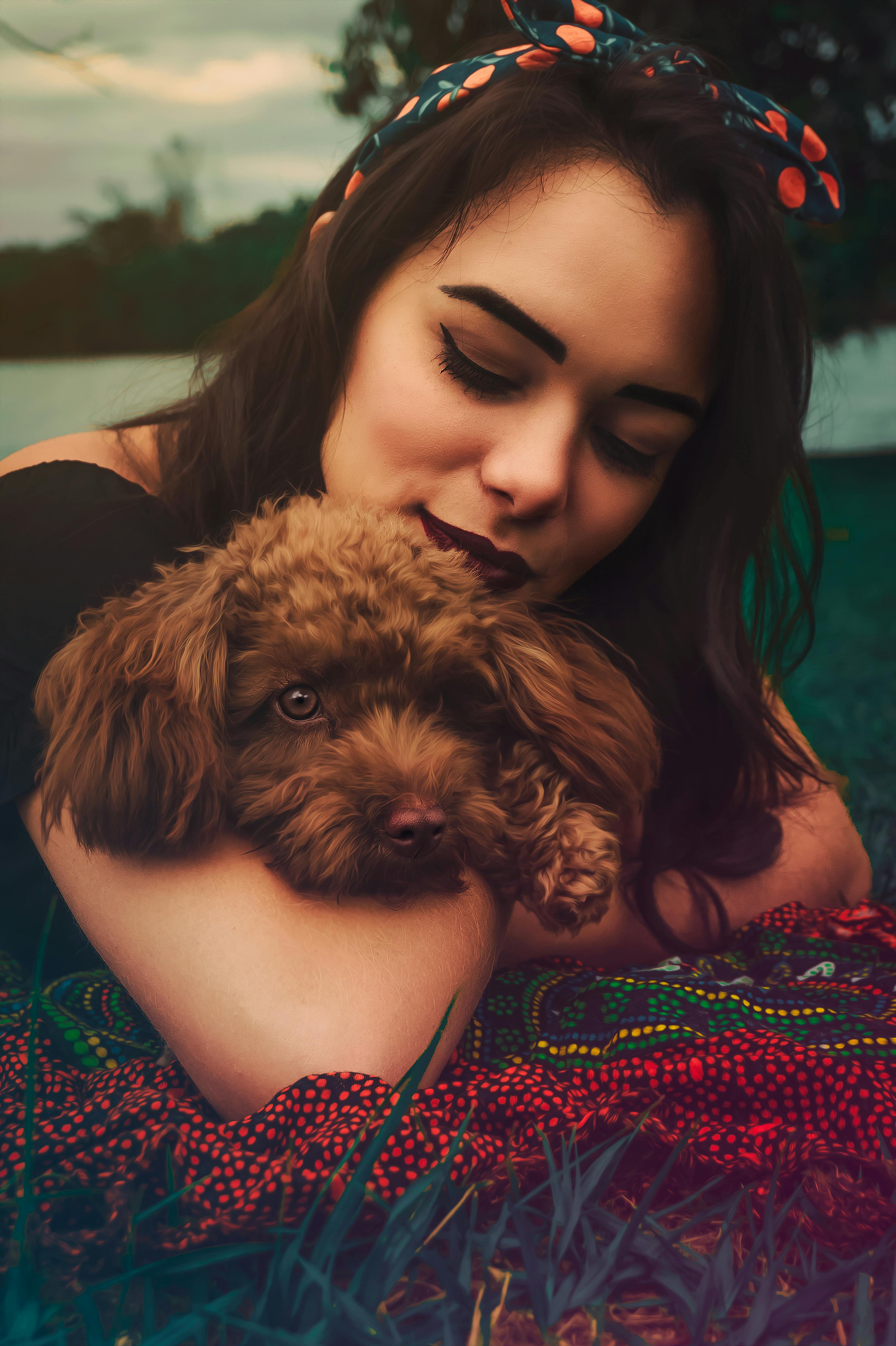 beautiful girl holding a cute brown dog