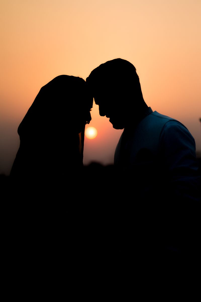 Omar and Salma facing each other at golden hour