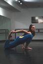 Woman in Blue Pants Stretching Leg Backwards